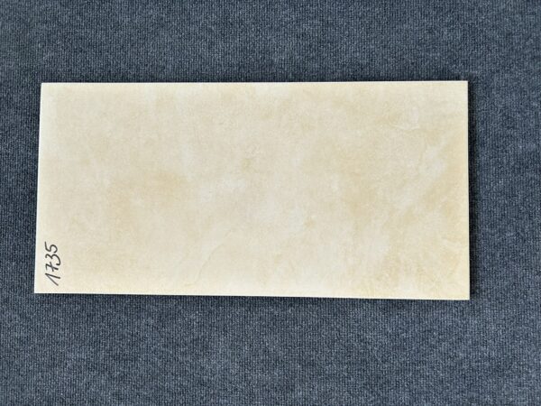 Foto einer einzelnen Bodenfliese Feinsteinzeug im Format 30 cm x 60 cm. Der Farbton ist ein helles Beige. Die Fliese besitzt ein leicht marmoriertes Design.